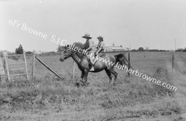 2 CHILDREN ON HORSE GOING TO SCHOOL